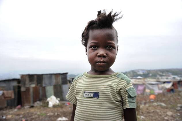 Jan. 26, 2010 - Port-Au-Prince, Haiti - 4-year-old ISMANI JOESEPH in the Canot neighborhood of Port-au-Prince. Ismani had half of her head shaved when a team of foreign doctors treated her for a head injury sustained during the earthquake. Temporary tent shelters in the hilltop Canot refuge are quickly being replaced by corogated tin-walled structures that are suggestive of a more permanent dwelling for people like Ismani.  - ZUMAt14_
