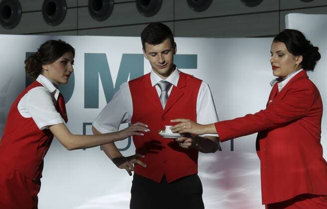 MOSCOW REGION, RUSSIA - JULY 12, 2016: Models showcase Austrian Airlines flight attendants uniform during the 2016 DME Runway fashion show marking International Flight Attendant Day at Domodedovo International Airport. Mikhail Metzel TASS  TS029C39