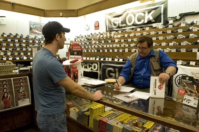 Oct. 2, 2010 - Kennesaw, GA, USA - Richard Neubaumayer, owner of Nick s Gun and Tackle shop, checks a Ruger LCP as a customer completes the required paperwork. The new gun owner wants the firearm for personal protection. - ZUMAn03_