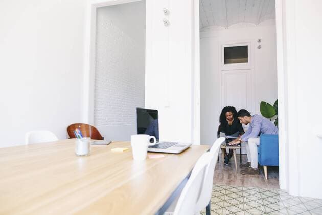 Young business people sitting and working on couch in office model released Symbolfoto property released  EBSF001445