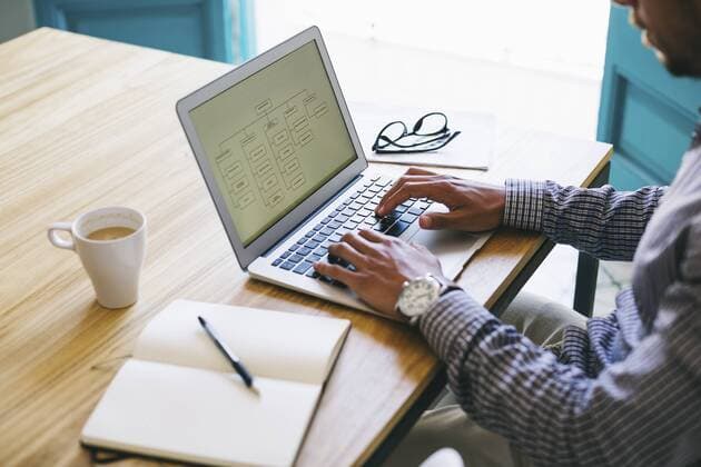 Young man in office using laptop model released Symbolfoto property released  EBSF001469