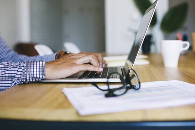 Young man in office using laptop model released Symbolfoto property released  EBSF001470