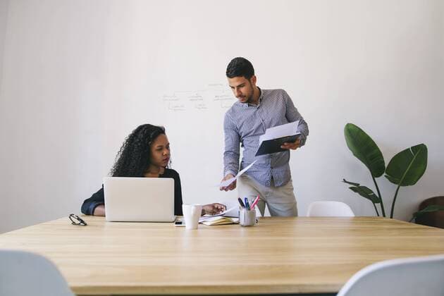 Young businessman and woman working together in office, using laptop model released Symbolfoto property released  EBSF001478