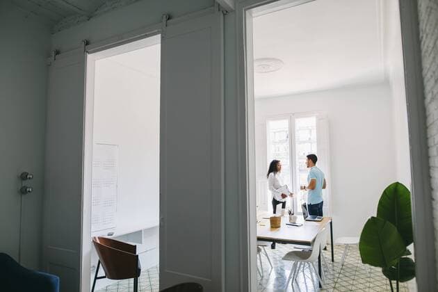 Two young business people discussing in office model released Symbolfoto property released  EBSF001501