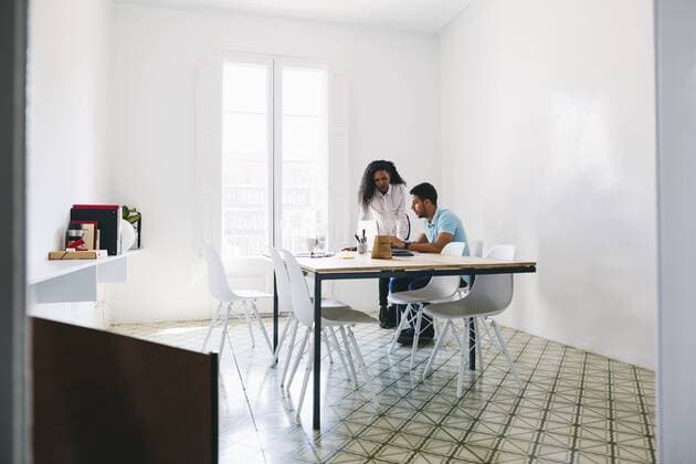 Young businessman and woman working together in office model released Symbolfoto property released  EBSF001502