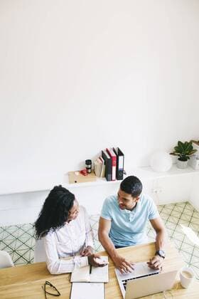 Young businessman and woman working together in office, using laptop model released Symbolfoto property released  EBSF001507
