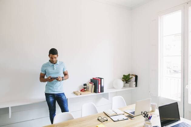 Young businessman in office using digital tablet model released Symbolfoto property released  EBSF001514