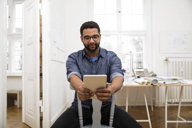 Young man using digital tablet in office model released Symbolfoto property released  FKF001855
