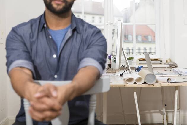 Man sitting on chair in office model released Symbolfoto property released  FKF001860