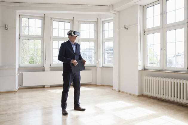 Real estate agent wearing virtual reality glasses in empty apartment model released Symbolfoto property released  RBF004686