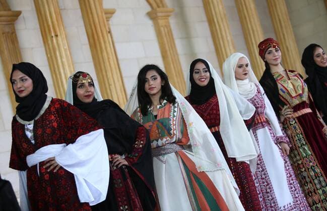 (160725) -- JENIN, July 25, 2016 -- Palestinian models display traditional Palestinian dresses during a fashion show in celebration of Palestinian Traditional Dress and Heritage Day at Haddad village near the West Bank city of Jenin, July 25, 2016. ) MIDEAST-JENIN-HERITAGE DAY AymanxNobani 