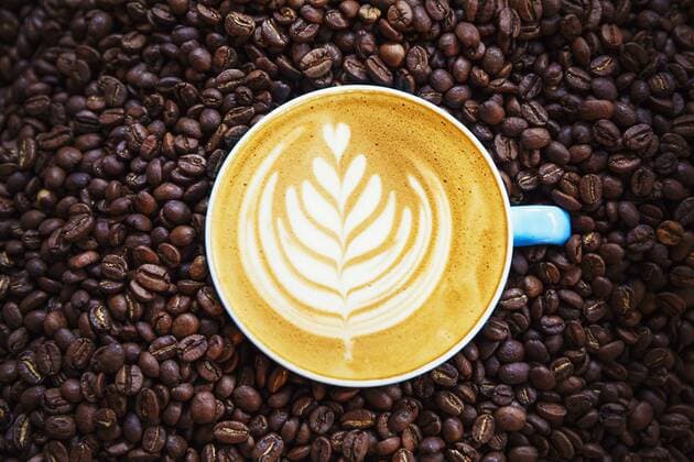 Specialist coffee shop. A woman seated at a counter by a roasting machine. Specialist coffee shop. A woman seated at a counter by a roasting machine.  23222