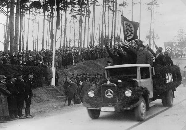 Photographic print of men standing in the back of a truck salute Hermann Goring and others during inaugural ceremonies for the newly opened Autobahn. WHA  !ACHTUNG AUFNAHMEDATUM GESCHÄTZT! Copyright: WHA UnitedArchivesWHA_072_0528