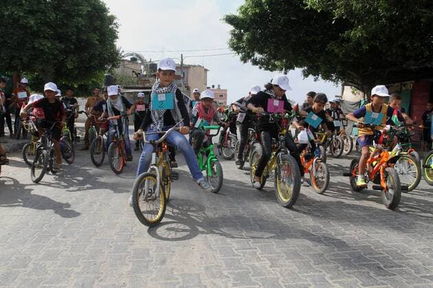August 7, 2016 - Rafah, Gaza Strip, Palestinian Territory - Palestinian children take part in the bicycles marathon to demand their right to play and break the siege on Gaza strip, in Rafah in the southern Gaza Strip. on August 7, 2016 Rafah Palestinian Territory - ZUMAap3_