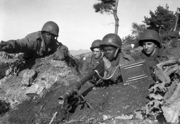 November 20, 1950 - Fighting with the 2nd Infantry Division north of the Chongchon River, a weapons squad leader points out communist-led North Korean position to his machine gun crew.  Copyright: StocktrekxImages stk105995m