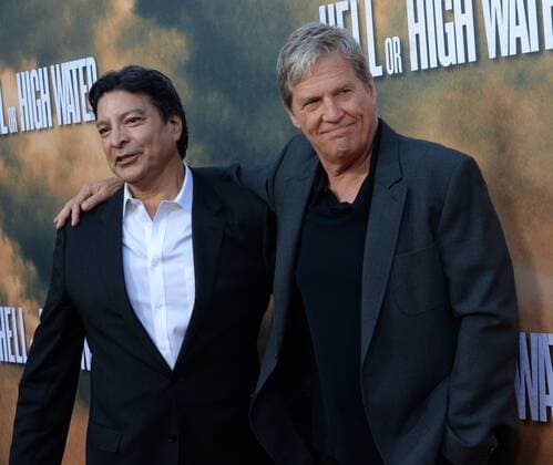 Cast members Gil Birmingham (L) and Jeff Bridges attend the premiere of the motion picture crime drama Hell or High Water at the ArcLight Cinema Dome in the Hollywood section of Los Angeles on August 10, 2016. Storyline: A divorced dad and his ex-con brother resort to a desperate scheme in order to save their family s farm in West Texas.  LAP2016081012 JIMxRUYMEN