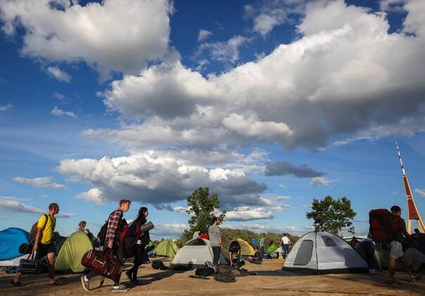 RIGA, LATVIA - AUGUST 11, 2016: People put up tents at 2016 KUBANA music festival on Lucavsala Island. Artyom Geodakyan TASS  TS02CC62