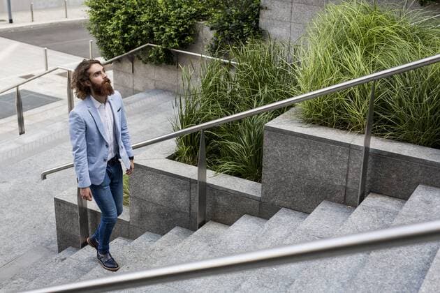 Stylish businessman walking on stairs outdoors model released Symbolfoto  MAUF000773