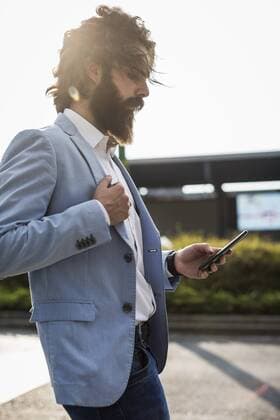 Stylish businessman using cell phone outdoors model released Symbolfoto  MAUF000774