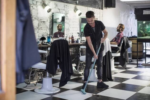 Barber sweeping in barber s shop model released Symbolfoto property released  ZEF009196