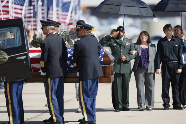 November 13, 2009_San Diego_California_USA_(LtoR) California Army National Guard Casuelity Assistance Officer Maj. Timothy Grimes and Christine Gaffaney, widow Army Capt. John Gaffaney and Matthew Gaffaney son of Army Capt. John Gaffaney of Serra Mesa who was killed at Fort Hood watch his casket being loaded into a hearse. Capt. Gaffaney was flown to MCAS Miramar to be handed over to his family._Mandatory Photo - ZUMAs44_