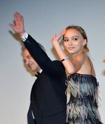 Lily-Rose Depp (R) and David Bennent wave to the audience as they walk offstage after cast introductions at the Toronto International Film Festival premiere of Planetarium at Roy Thomson Hall in Toronto, Canada on September 10, 2016.  TOR2016091039 CHRISTINExCHEW