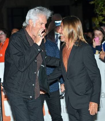 Director Jim Jarmusch (L) and singer Iggy Pop chat privately as they arrive at the Toronto International Film Festival premiere of Gimme Danger at Ryerson Theatre in Toronto, Canada on September 14, 2016.  TOR2016091416 CHRISTINExCHEW