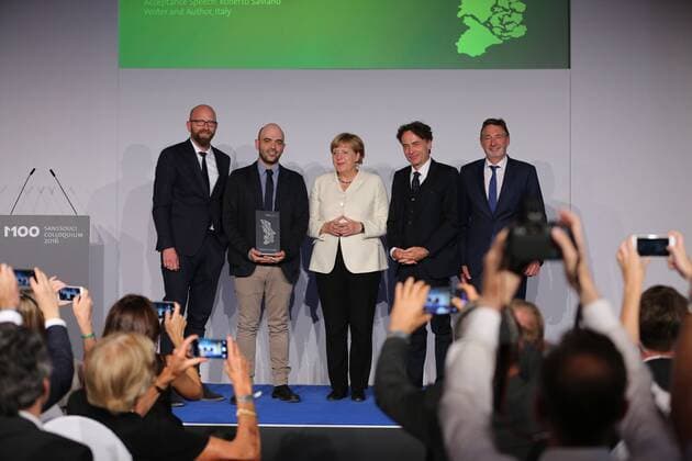 Presentation of the M100 Media Prize in Potsdam The presentation of the M100 Media Prize in the Orangery Palace in Potsdam was attended by Chancellor Dr. Angela Merkel, Roberto Saviano, author ( Gomorrah ), journalist and M100 Media Award winners 2016 Giobanni di Lorenzo, editor in chief, Die Zeit and Jann Jakobs, Lord Mayor of Landeshauptstad Potsdam.  SimonexKuhlmey