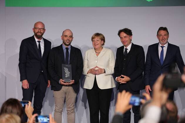Presentation of the M100 Media Prize in Potsdam The presentation of the M100 Media Prize in the Orangery Palace in Potsdam was attended by Chancellor Dr. Angela Merkel, Roberto Saviano, author ( Gomorrah ), journalist and M100 Media Award winners 2016 Giobanni di Lorenzo, editor in chief, Die Zeit and Jann Jakobs, Lord Mayor of Landeshauptstad Potsdam.  SimonexKuhlmey