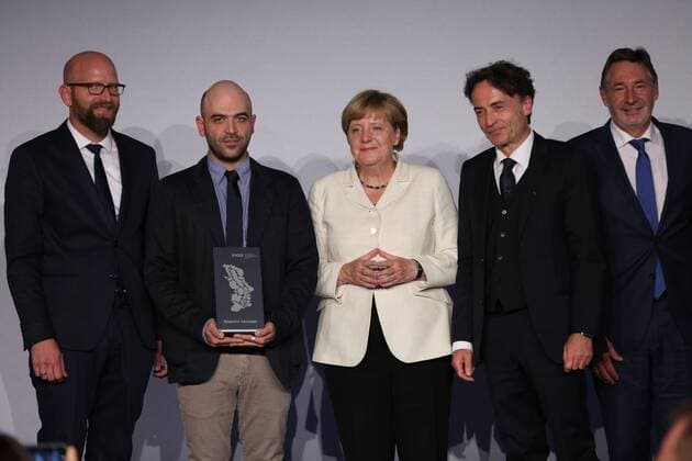 Presentation of the M100 Media Prize in Potsdam The presentation of the M100 Media Prize in the Orangery Palace in Potsdam was attended by Chancellor Dr. Angela Merkel, Roberto Saviano, author ( Gomorrah ), journalist and M100 Media Award winners 2016 Giobanni di Lorenzo, editor in chief, Die Zeit and Jann Jakobs, Lord Mayor of Landeshauptstad Potsdam.  SimonexKuhlmey