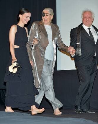 Rooney Mara (L) and Vanessa Redgrave walk out barefoot onto the stage with an assist from director Jim Sheridan (R) for the cast introductions at the Toronto International Film Festival premiere of The Secret Scripture at Roy Thomson Hall in Toronto, Canada on September 15, 2016.  TOR2016091519 CHRISTINExCHEW