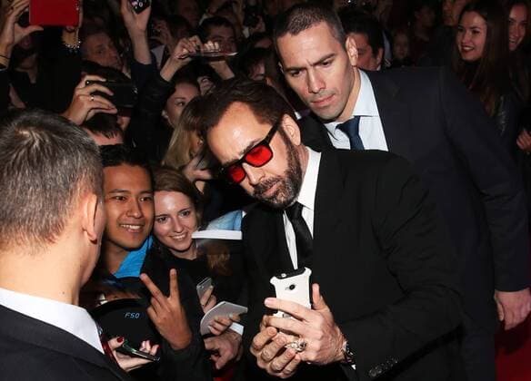 MOSCOW, RUSSIA - SEPTEMBER 20, 2016: American actor Nicolas Cage (C) takes a selfie with fans at the Russian premiere of a new action film, USS Indianapolis: Men of Courage, directed by Mario Van Peebles, at the 5 Zvyozd Na Paveletskoi Cinema Hall. Vyacheslav Prokofyev TASS  TS031CFF