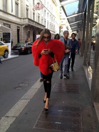 Milan, Fur heart-shaped E began the week of women s fashion, and in the center there s people wearing some curious heads and extravagant, albeit signed. In the photo a girl walks in via Montenapoleone wearing a fur coat in a heart shape, a Moschino s signature.  Copyright: xMimmoxCarrierox