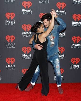 Olympic gymnast Laurie Hernandez and Val Chmerkovskiy arrive for the iHeartRadio Music Festival at the T-Mobile Arena in Las Vegas, Nevada on September 23, 2016.  LVP2016092362 JAMESxATOA