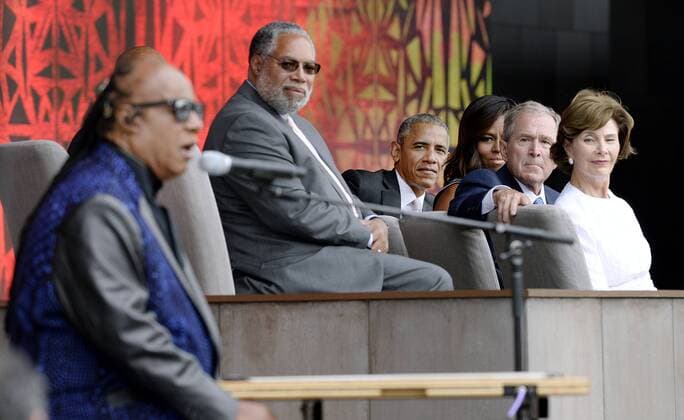 (R to L) : Former First Lady Laura Bush, former President George W. Bush, U.S President Barack Obama and First Lady Michelle Obama listen to singer Stevie Wonder during the opening ceremony of the Smithsonian National Museum of African American History and Culture on September 24, 2016 in Washington, DC. The museum is opening thirteen years after Congress and President George W. Bush authorized its construction. Pool  WAX20160924112 OlivierxDouliery