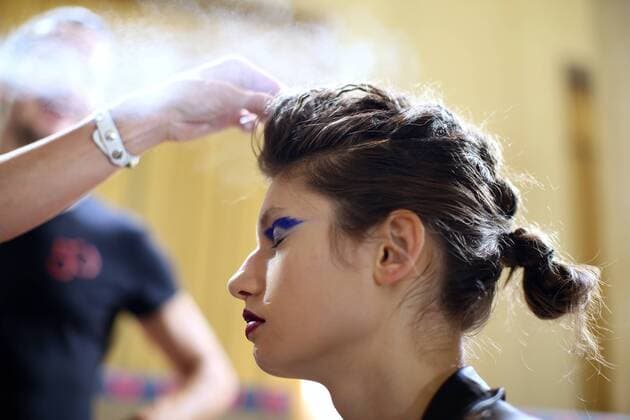 MILAN, Sept. 24, 2016 -- A model has her make-up applied backstage before the Leitmotiv show as part of Milan Fashion Week Spring Summer 2017 in Milan, Italy, on Sept. 24, 2016. )(axy) ITALY-MILAN-FASHION WEEK-LEITMOTIV JinxYu 