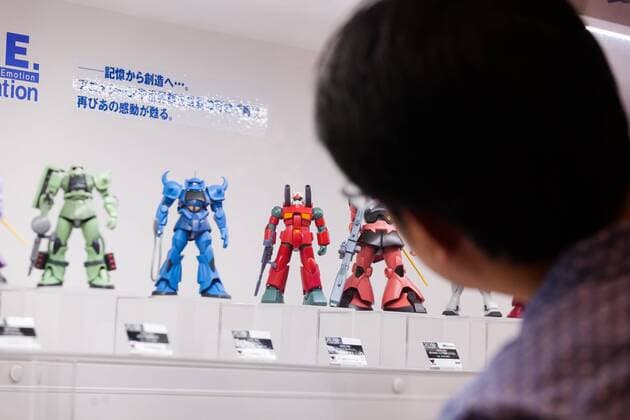 A visitor looks at a Gundam action figures on display at the 56th All Japan Model & Hobby Show in Tokyo Big Sight on September 25, 2016. The exhibition introduced hobby goods such as plastic models, action figures, drones, and airsoft guns.  (gxta_alljpnmodelhobbyshow027)
