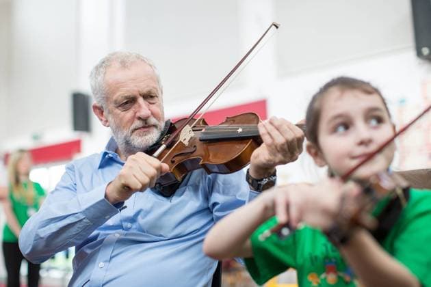Bilder des Tages September 27, 2016 - Liverpool, Merseyside, UK - Liverpool , UK . Labour Party leader JEREMY CORBYN is shown how to play the violin by JESSICA KELLY (10) during a visit to Faith Primary School in Liverpool , where he listens to and then joins in with the school orchestra Liverpool UK  - ZUMAl94_