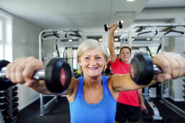 Mature woman and senior man working out in fitness gym model released Symbolfoto property released  HAPF000782
