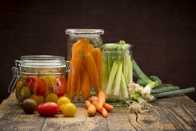 Pickled spring onions and fermented carrots in glasses  LVF005254