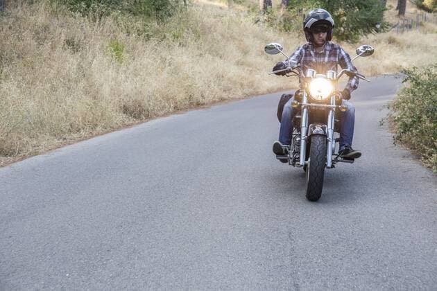 Man riding motorbike on open road model released Symbolfoto  ABZF001138
