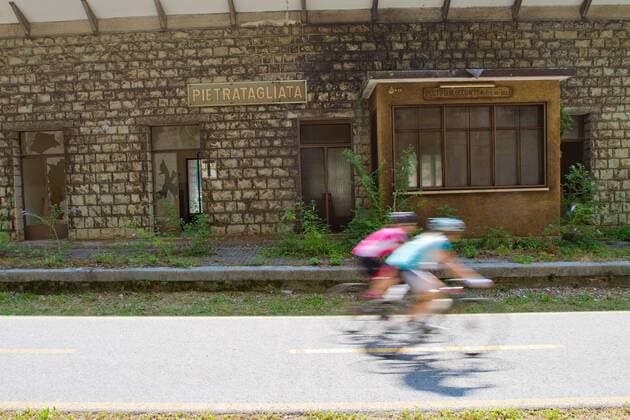Rennradfahrer vor einer alten Bahnstation auf dem Alpe Adria-Weg zwischen Villach und Venzone Nord-Italien Italien Alpe-Adria-Weg