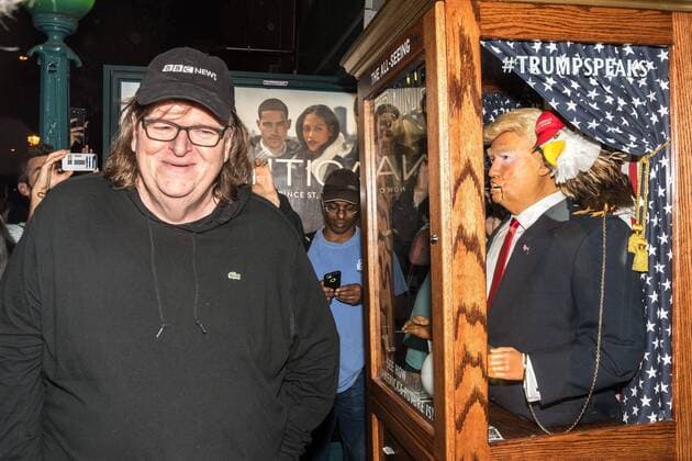 US filmmaker Michael Moore walks away laughing after listening to a fortune-telling fairground attraction representing Republican presidential candidate Donald Trump upon arriving to a New York theater to attend the premiere of his documentary Michael Moore In TrumpLand on October 18, 2016. Moore had finished editing the film the previous day and made a surprise last-minute announcement on Twitter that he would show it for free today. The film will play for a week in Los Angeles and New York starting tomorrow. Photo by Enrique Shore Cordon Press  ENRIQUExSHORE Director Moore laughs at robot of Trump before premiere of his d