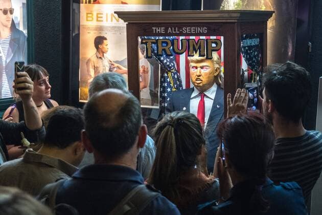 People surround and photograph a fortune-telling fairground attraction representing Republican presidential candidate Donald Trump outside a New York theater screening the premiere of the documentary Michael Moore In TrumpLand on October 18, 2016. Filmmaker Michael Moore had finished editing the film the previous day and made a surprise last-minute announcement on Twitter that he would show it for free today. The film will play for a week in Los Angeles and New York starting tomorrow. Photo by Enrique Shore Cordon Press  ENRIQUExSHORE People surround robot of Trump before the premiere of the docume