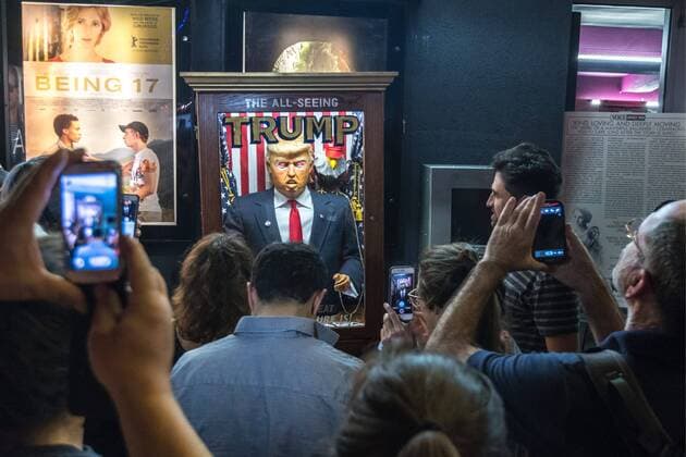 People surround and photograph a fortune-telling fairground attraction representing Republican presidential candidate Donald Trump outside a New York theater screening the premiere of the documentary Michael Moore In TrumpLand on October 18, 2016. Filmmaker Michael Moore had finished editing the film the previous day and made a surprise last-minute announcement on Twitter that he would show it for free today. The film will play for a week in Los Angeles and New York starting tomorrow. Photo by Enrique Shore Cordon Press  ENRIQUExSHORE People surround robot of Trump before premiere of his documentar