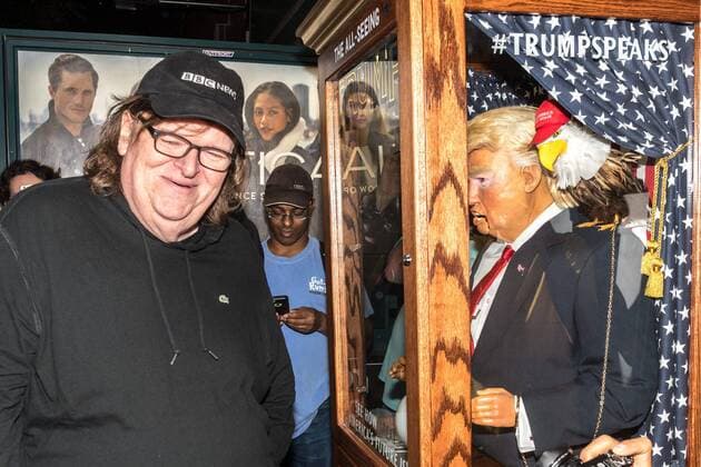 US filmmaker Michael Moore laughs as he listens to a fortune-telling fairground attraction representing Republican presidential candidate Donald Trump upon arriving to a New York theater to attend the premiere of his documentary Michael Moore In TrumpLand on October 18, 2016. Moore had finished editing the film the previous day and made a surprise last-minute announcement on Twitter that he would show it for free today. The film will play for a week in Los Angeles and New York starting tomorrow. Photo by Enrique Shore Cordon Press  ENRIQUExSHORE Director Moore watches robot of Trump before premiere of his doc