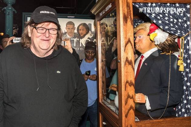 US filmmaker Michael Moore walks away laughing after listening to a fortune-telling fairground attraction representing Republican presidential candidate Donald Trump upon arriving to a New York theater to attend the premiere of his documentary Michael Moore In TrumpLand on October 18, 2016. Moore had finished editing the film the previous day and made a surprise last-minute announcement on Twitter that he would show it for free today. The film will play for a week in Los Angeles and New York starting tomorrow. Photo by Enrique Shore Cordon Press  ENRIQUExSHORE Director Moore laughs at robot of Trump before premiere of his d