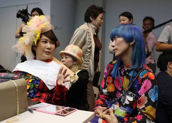 October 19, 2016, Tokyo, Japan - Japanese transgender actress Ai Haruna (L) chats with designer Takafumi Tsuruta as they prepare for the tenbo 2017 spring summer collection as a part of Japan Fashion Week in Tokyo on Wednesday, October 19, 2016.  (lwxa005547)