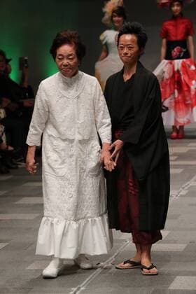 October 19, 2016, Tokyo, Japan - Former reprosy patient Miyo Maki (L) displays a creation of Japanese designer Takafumi Tsuruta at the tenbo 2017 spring summer collection as a part of Japan Fashion Week in Tokyo on Wednesday, October 19, 2016.  (lwxa005575)