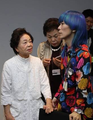 October 19, 2016, Tokyo, Japan - Former leprosy patient Miyo Maki (L) chats with designer Takafumi Tsuruta as they prepare for the tenbo 2017 spring summer collection as a part of Japan Fashion Week in Tokyo on Wednesday, October 19, 2016.  (lwxa005579)